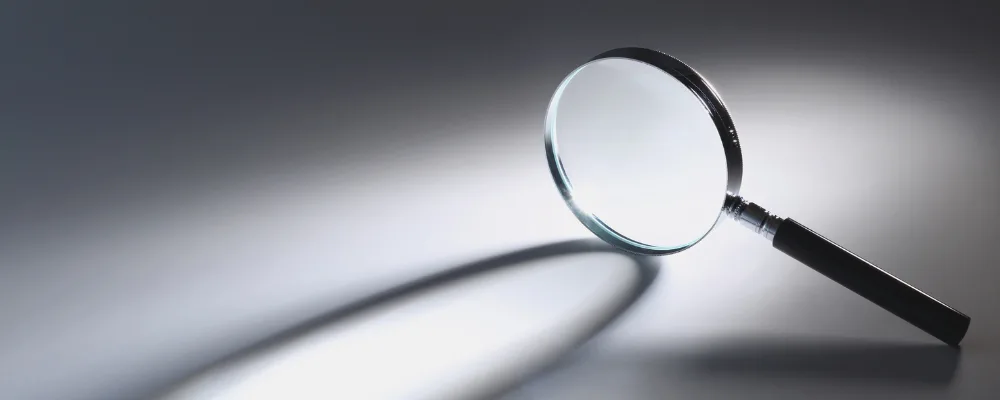 Magnifying glass on grey shadow background
